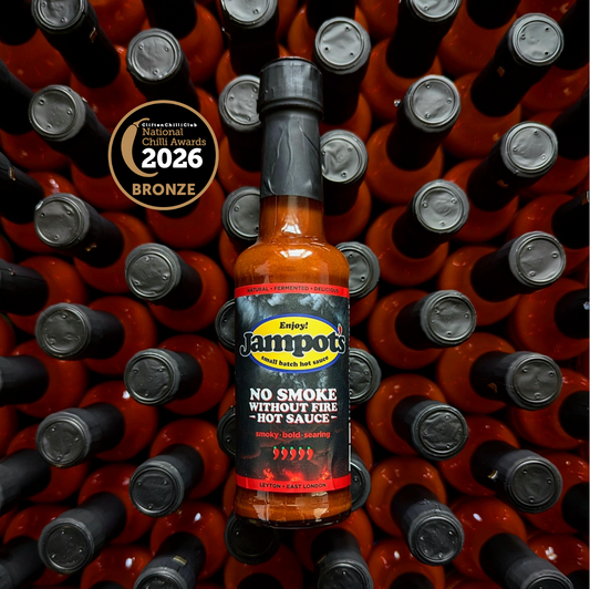 Jampot's "No Smoke Without Fire" hot sauce bottle with awards on a background of similar bottles