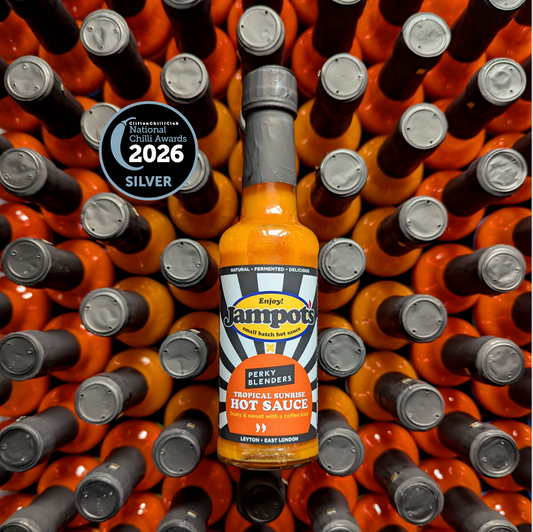 Jampot's Tropical Sunrise featuring "Perky Blenders" hot sauce bottle surrounded by other bottles with a 2026 Silver Award badge