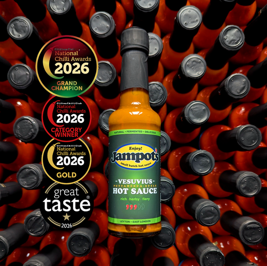 Jampot's award-winning, "Vesuvius" - Puttanesca-style hot sauce bottle, with awards on a background of more hot sauce bottles