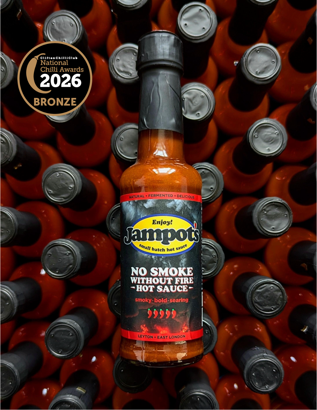 Jampot's "No Smoke Without Fire" hot sauce bottle with awards on a background of similar bottles