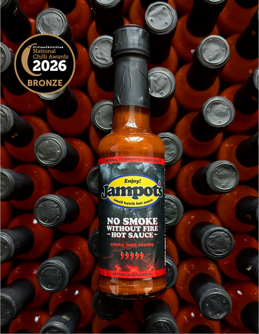 Jampot's "No Smoke Without Fire" hot sauce bottle with awards on a background of similar bottles
