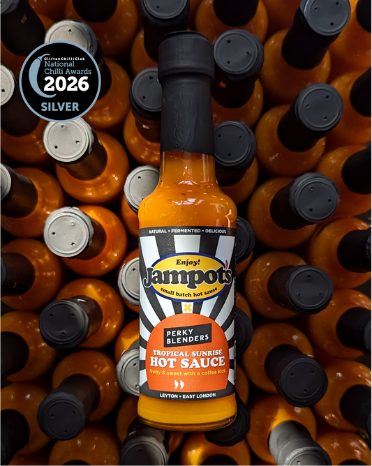 Jampot's Tropical Sunrise featuring "Perky Blenders" hot sauce bottle surrounded by other bottles with a 2026 Silver Award badge