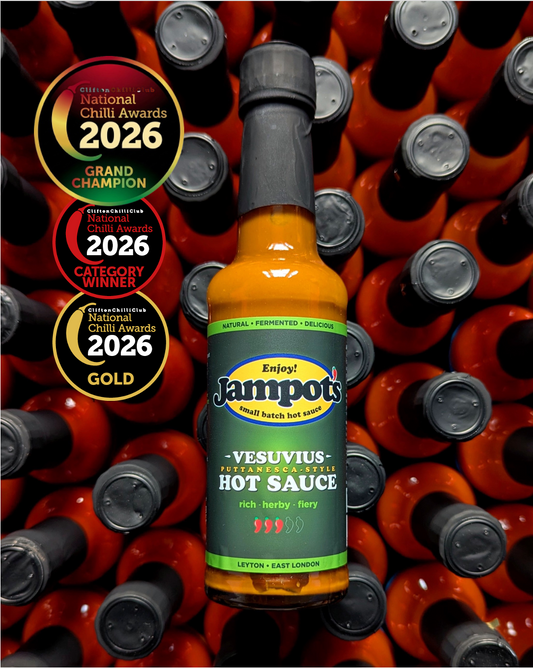 Jampot's award-winning, "Vesuvius" - Puttanesca-style hot sauce bottle, with awards on a background of more hot sauce bottles